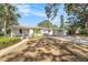 Charming single-story home featuring a spacious driveway and an open carport with landscaping at 4925 Alcazar S Way, St Petersburg, FL 33712