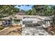 Aerial view of single-story home featuring a spacious driveway and an open carport at 4925 Alcazar S Way, St Petersburg, FL 33712