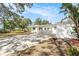 Charming single-story home featuring a spacious driveway and an open carport, blue skies at 4925 Alcazar S Way, St Petersburg, FL 33712