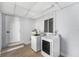 Well-lit laundry room with modern machines, water heater, storage, and durable flooring at 4925 Alcazar S Way, St Petersburg, FL 33712