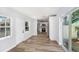 Bright living room with hardwood floors, leading to an open-concept kitchen with stainless steel appliances at 4925 Alcazar S Way, St Petersburg, FL 33712