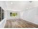 Bright living room featuring wood floors, large windows, and neutral walls at 4925 Alcazar S Way, St Petersburg, FL 33712