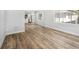 Open-concept room with wood floors, view into kitchen, and large windows for natural light at 4925 Alcazar S Way, St Petersburg, FL 33712