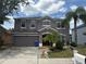 Charming two-story home featuring an attached two-car garage and a well-maintained landscaped front yard at 11317 Village Brook Dr, Riverview, FL 33579