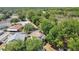 Aerial view of the home showcasing its prime location surrounded by lush trees and greenery at 12219 Hunters Lake Dr, New Port Richey, FL 34654