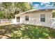 Spacious backyard featuring a concrete patio, and mature landscaping at 12219 Hunters Lake Dr, New Port Richey, FL 34654