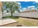 Large backyard features a well-maintained white fence and a mature shade tree at 12219 Hunters Lake Dr, New Port Richey, FL 34654