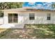 Backyard features a concrete patio and sliding glass doors allowing seamless indoor/outdoor living at 12219 Hunters Lake Dr, New Port Richey, FL 34654