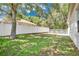 Large backyard offers a privacy fence, mature trees, and lush green grass at 12219 Hunters Lake Dr, New Port Richey, FL 34654