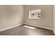 Simple bedroom with wood floors, a window, and neutral walls for versatile decor at 12219 Hunters Lake Dr, New Port Richey, FL 34654