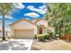 Inviting home with a manicured lawn and a two-car garage, plus mature landscaping at 12219 Hunters Lake Dr, New Port Richey, FL 34654