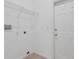 Bright laundry room features tile flooring, a utility sink hook-up, wire shelving, and a white door at 12219 Hunters Lake Dr, New Port Richey, FL 34654
