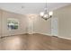 Bright living room with hardwood floors, large windows, and neutral wall paint at 12219 Hunters Lake Dr, New Port Richey, FL 34654