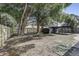Fenced backyard with mature trees, utility shed and covered parking area at 1807 49Th W Ave, Bradenton, FL 34207