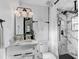 Modern bathroom featuring a marble tiled shower, updated vanity, and stylish fixtures and lighting at 1807 49Th W Ave, Bradenton, FL 34207