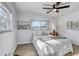 Bright bedroom with neutral decor, ceiling fan, two windows, and a bedside table with lamp at 1807 49Th W Ave, Bradenton, FL 34207
