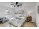 Bright bedroom with neutral decor, ceiling fan, two windows, and a bedside table with lamp at 1807 49Th W Ave, Bradenton, FL 34207