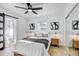 Bright bedroom with neutral decor, ceiling fan, barn door, and a mirrored closet at 1807 49Th W Ave, Bradenton, FL 34207