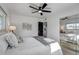 Bright bedroom with a ceiling fan, natural light, and mirrored closet doors at 1807 49Th W Ave, Bradenton, FL 34207