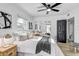 Bright bedroom with neutral decor, ceiling fan, barn door, and a mirrored closet at 1807 49Th W Ave, Bradenton, FL 34207