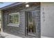 Detailed view of the front door showcasing stone accents and modern house numbers at 1807 49Th W Ave, Bradenton, FL 34207