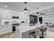 Open kitchen design with marble countertops, stainless appliances, kitchen island, and view into the living room at 1807 49Th W Ave, Bradenton, FL 34207