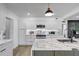 Bright kitchen featuring white cabinetry, stainless steel appliances, and a marble island with a black faucet at 1807 49Th W Ave, Bradenton, FL 34207