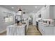 Modern kitchen with white cabinetry, marble countertops, stainless steel appliances, and island at 1807 49Th W Ave, Bradenton, FL 34207