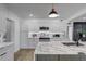 Bright kitchen featuring white cabinetry, stainless steel appliances, and a marble island with a black faucet at 1807 49Th W Ave, Bradenton, FL 34207