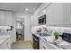 This well-lit kitchen has white cabinetry, stainless steel appliances, and marble countertops at 1807 49Th W Ave, Bradenton, FL 34207