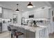 Modern kitchen featuring white cabinets, stainless steel appliances, and a large marble island with seating at 1807 49Th W Ave, Bradenton, FL 34207