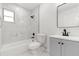 Renovated bathroom with marble-style tile shower, modern vanity, and updated fixtures at 1820 Marvy Ave, Tampa, FL 33612