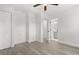 Spacious bedroom with light gray wood floors, ceiling fan, and access to the ensuite bathroom at 1820 Marvy Ave, Tampa, FL 33612