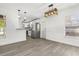 Open dining area with modern light fixture and view of the updated kitchen with stainless steel appliances at 1820 Marvy Ave, Tampa, FL 33612