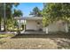 Inviting front porch with charming columns, offering a relaxing space to enjoy the neighborhood views at 1820 Marvy Ave, Tampa, FL 33612