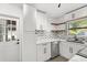 Updated kitchen with stainless steel dishwasher, undermount sink, and white cabinets at 1820 Marvy Ave, Tampa, FL 33612