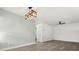 Spacious living area featuring modern lighting, light gray wood floors, and neutral paint at 1820 Marvy Ave, Tampa, FL 33612