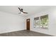 Sun-filled living room featuring hardwood floors, a ceiling fan, and a large window at 1820 Marvy Ave, Tampa, FL 33612