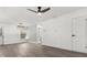 Bright living room with light gray wood floors, a modern ceiling fan, and access to the bathroom at 1820 Marvy Ave, Tampa, FL 33612