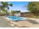 Refreshing backyard pool surrounded by lush greenery and a privacy fence for outdoor enjoyment at 1820 Marvy Ave, Tampa, FL 33612
