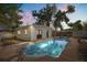 Backyard features an in-ground swimming pool with a white pool house and fenced yard at 1820 Marvy Ave, Tampa, FL 33612
