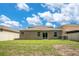 Expansive backyard featuring green grass, a privacy fence, and the home's exterior at 3504 Kearsney Abbey Cir, Dover, FL 33527