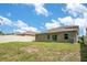 Spacious backyard featuring green grass, a privacy fence, and a view of the home's exterior at 3504 Kearsney Abbey Cir, Dover, FL 33527