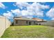 Large backyard with healthy grass, a privacy fence, and the exterior view of the home at 3504 Kearsney Abbey Cir, Dover, FL 33527