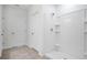 Bathroom featuring a white shower stall with tiled walls, a shower head, a small niche, and a door to the left at 3504 Kearsney Abbey Cir, Dover, FL 33527