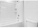 Bright bathroom featuring a white tiled tub and shower combination, with modern fixtures and a streamlined design at 3504 Kearsney Abbey Cir, Dover, FL 33527