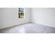 This bedroom features tiled floor, white walls and a window offering natural light at 3504 Kearsney Abbey Cir, Dover, FL 33527