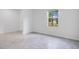 Bedroom features tiled floor, white walls and a window offering natural light at 3504 Kearsney Abbey Cir, Dover, FL 33527