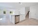 Kitchen island with a stainless steel dishwasher, sink, and granite countertops at 3504 Kearsney Abbey Cir, Dover, FL 33527