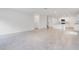 Open-concept living space with tile flooring and abundant natural light flows into the kitchen at 3504 Kearsney Abbey Cir, Dover, FL 33527